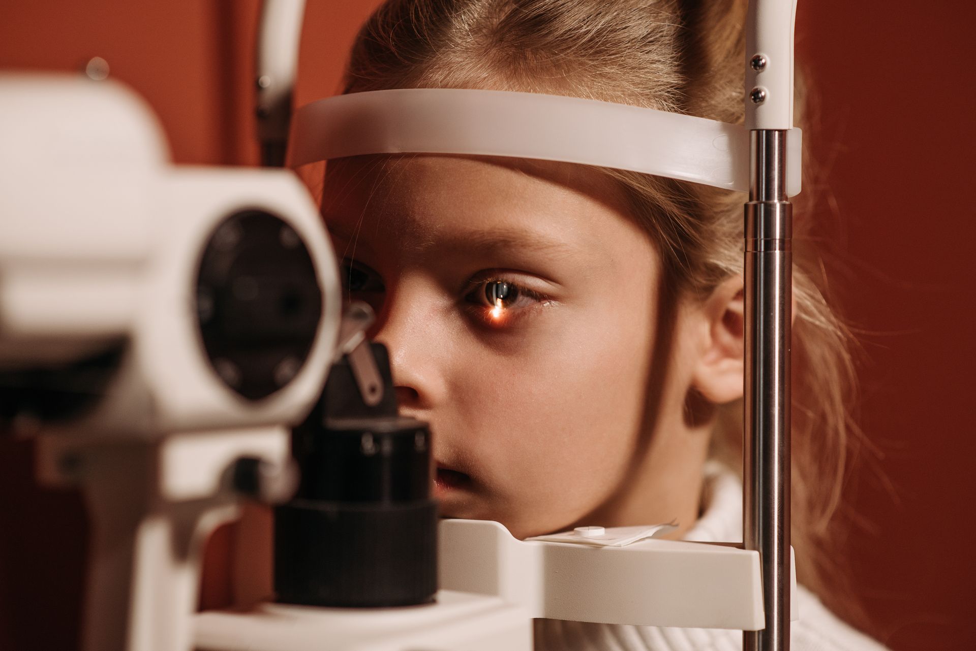 An eye-care professional examining a child's vision