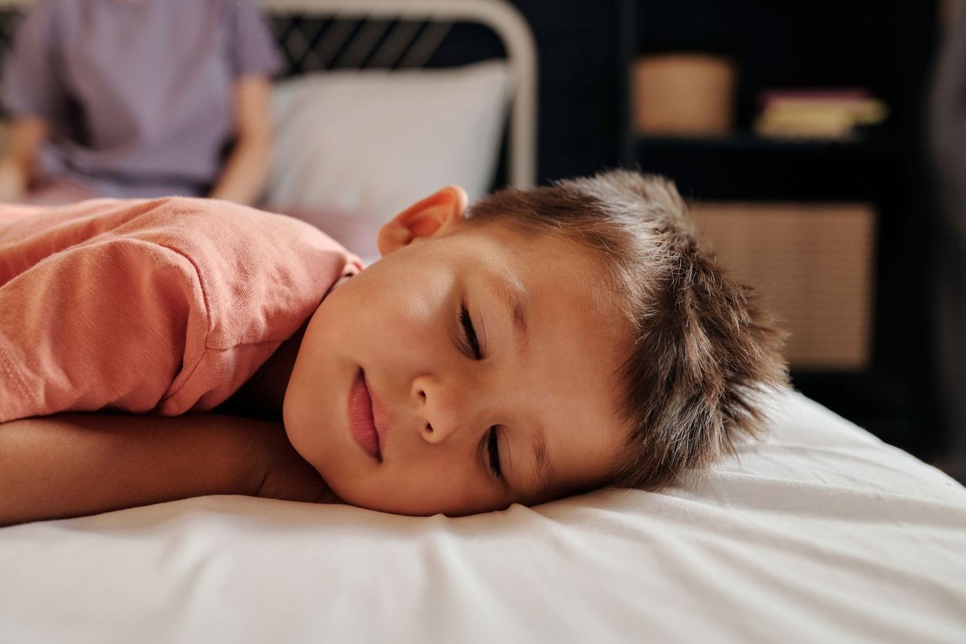 A young boy asleep in bed