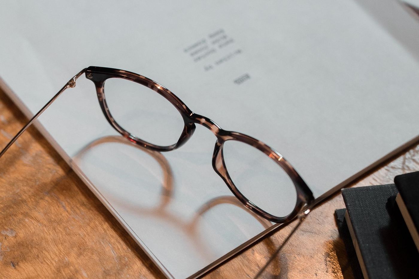 A pair of eyeglasses resting on an open notebook